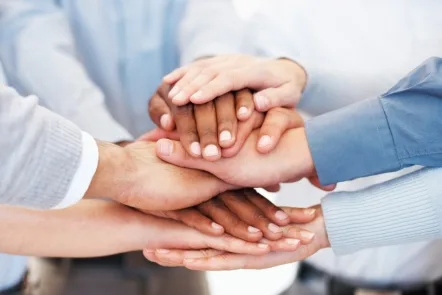 Several diverse hands stacked together